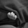 Photo by Hannah Barata: https://www.pexels.com/photo/little-baby-covered-with-blanket-in-black-and-white-19751874/