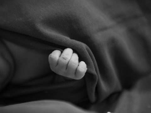 Photo by Hannah Barata: https://www.pexels.com/photo/little-baby-covered-with-blanket-in-black-and-white-19751874/