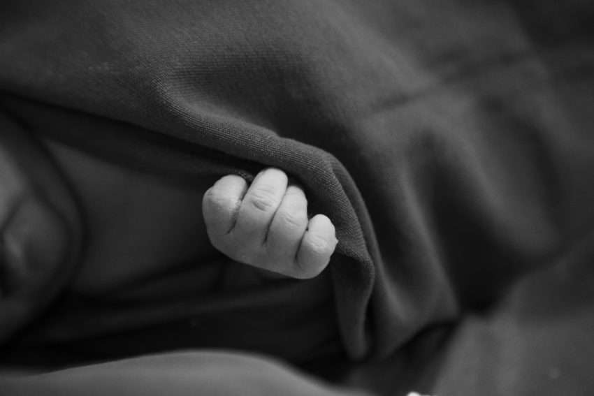 Photo by Hannah Barata: https://www.pexels.com/photo/little-baby-covered-with-blanket-in-black-and-white-19751874/